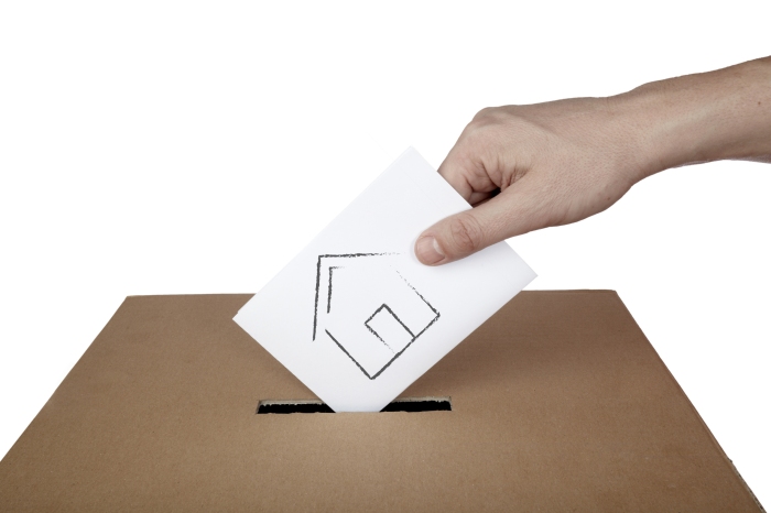 close up of hand and voting ballot